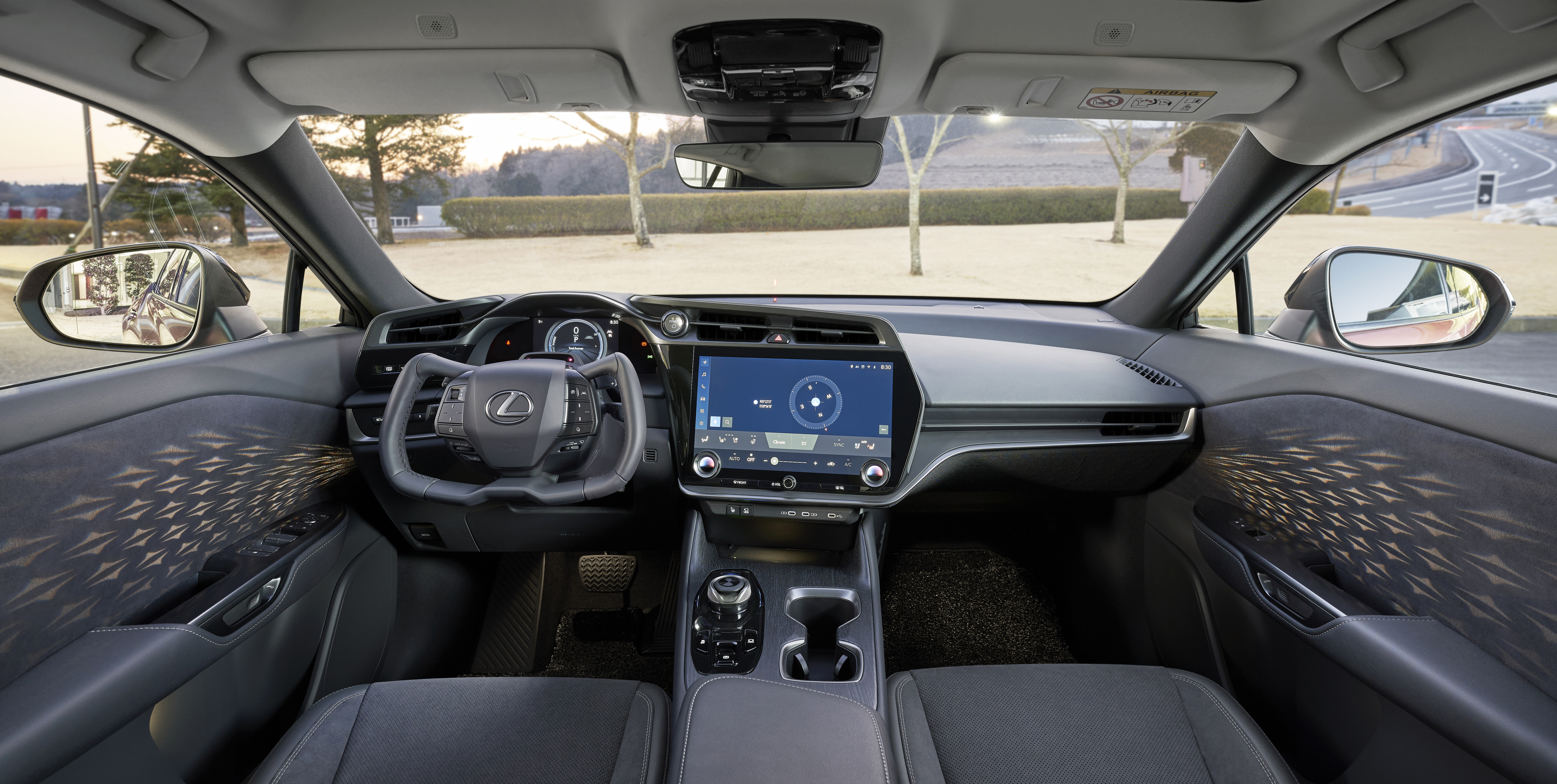 The yoke-style steering wheel and 14-inch touch screen of RZ with ambient lighting design.