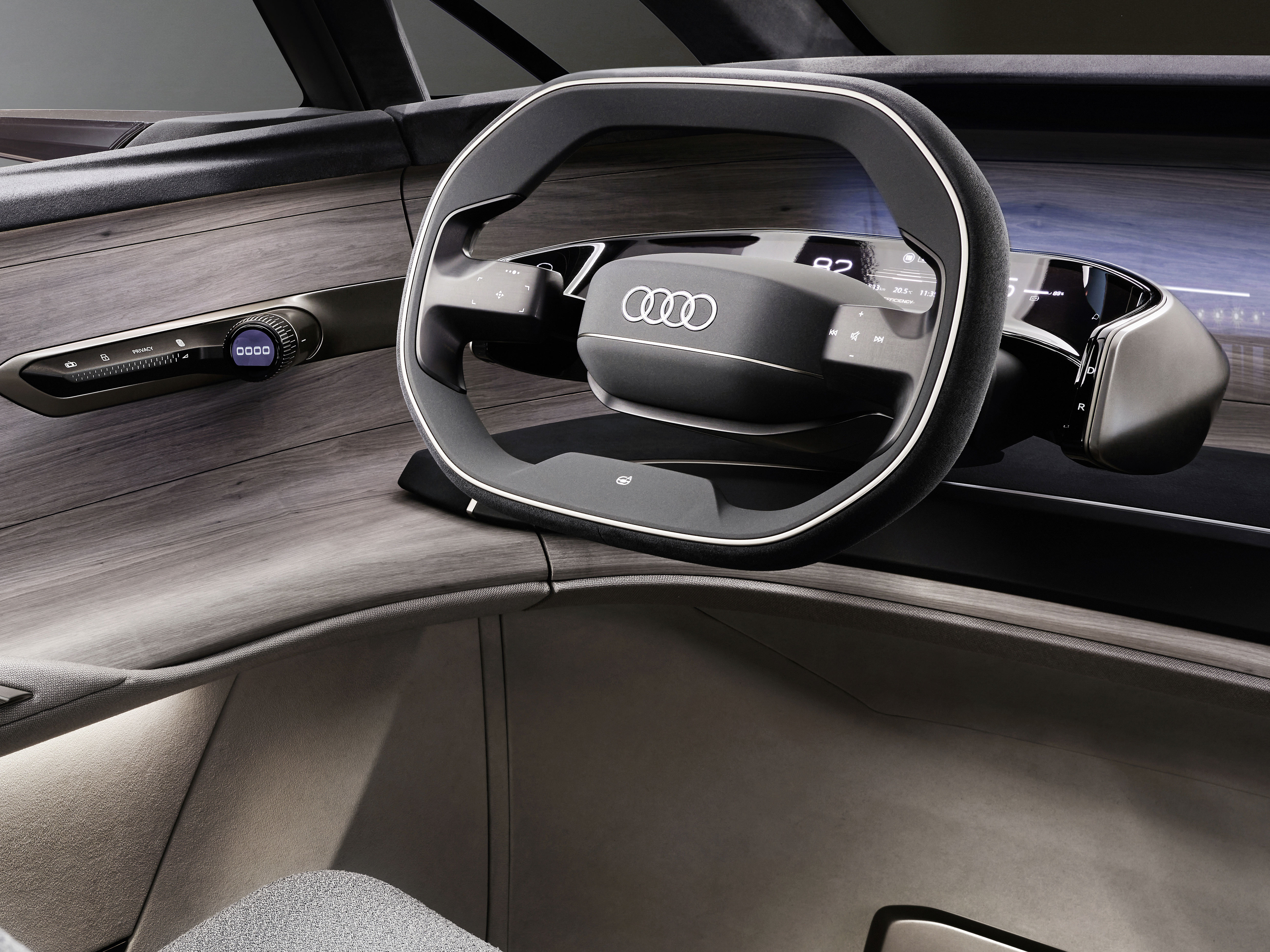 The "Four Rings" on the left side of the steering wheel and the driver's left hand are the personified image of Audi's new digital assistant