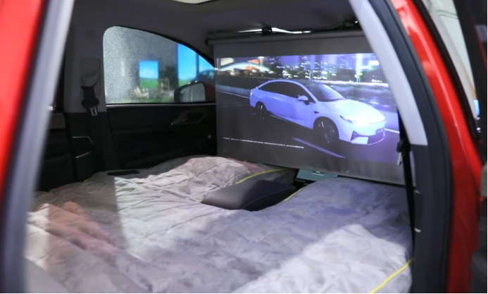 In the X-Play scenario, you can lie in the car and watch a movie.