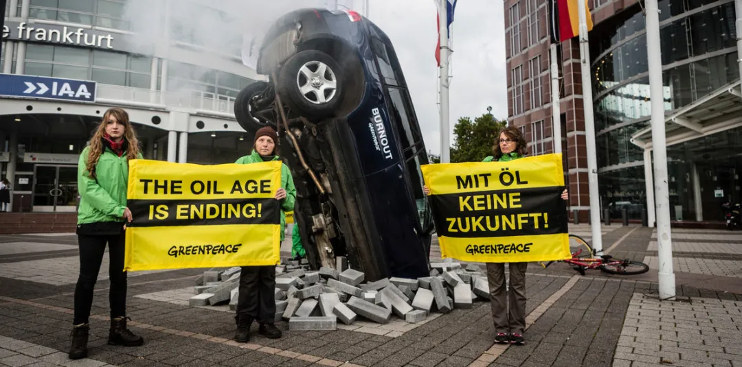 Greenpeace protests outside the exhibition hall at the 2019 Frankfurt Motor Show. The banner reads, "The Age of Oil is Over."