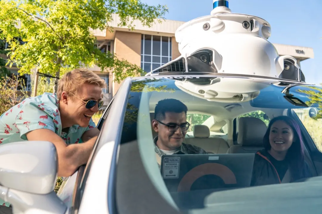 A person sitting in a self-driving car