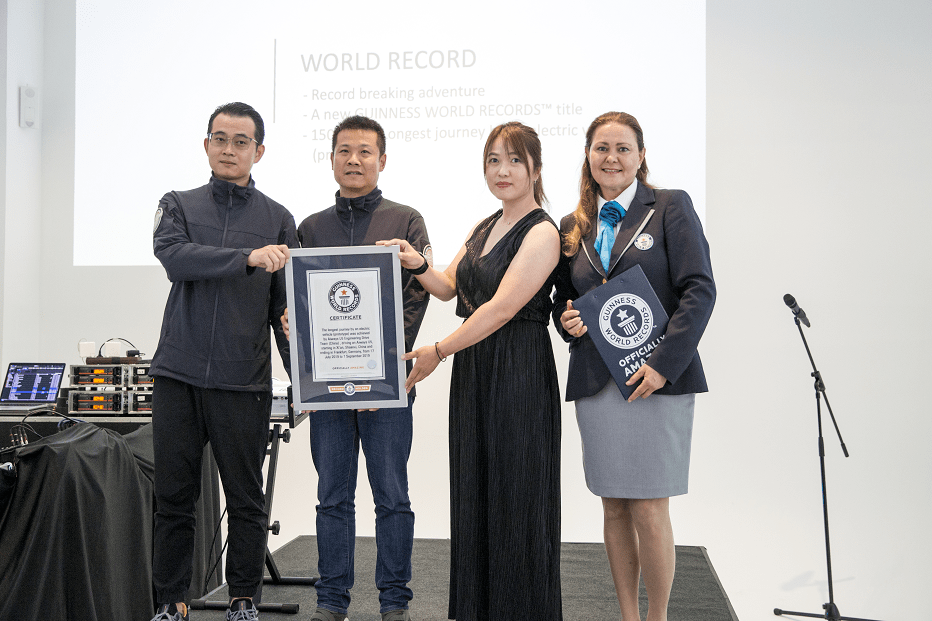 Caption: "Aiways U5 Asia-Europe Crossing Challenge" press conference certificate presentation for Guinness World Records by the certification officer
